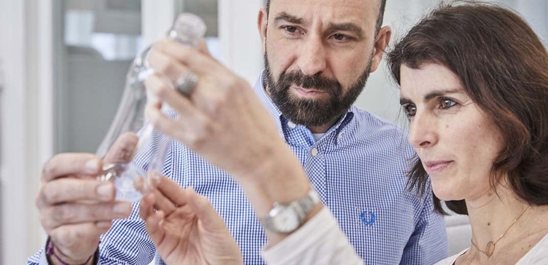 employees looking at plastic bottle